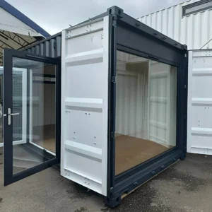 20ft x 8ft Custom Shipping Container Conversion – Portable Building Key Features (As Shown in This 20ft Model) Base Container Options: 20ft x 8ft High Cube Container (9′6″ high) or 20ft x 8ft Standard Container (8′6″ high) Exterior Finish: Full external respray in Anthracite Grey Internal respray in White for a bright interior Chrome container handles for a polished look Entry & Access: Manual Roller Shutter Door (2000 × 1000 mm), steel shopfront style, powder-coated finish with bullet locks for security Double-Glazed Anthracite Grey French Doors (2000 × 2200 mm) – stylish and secure